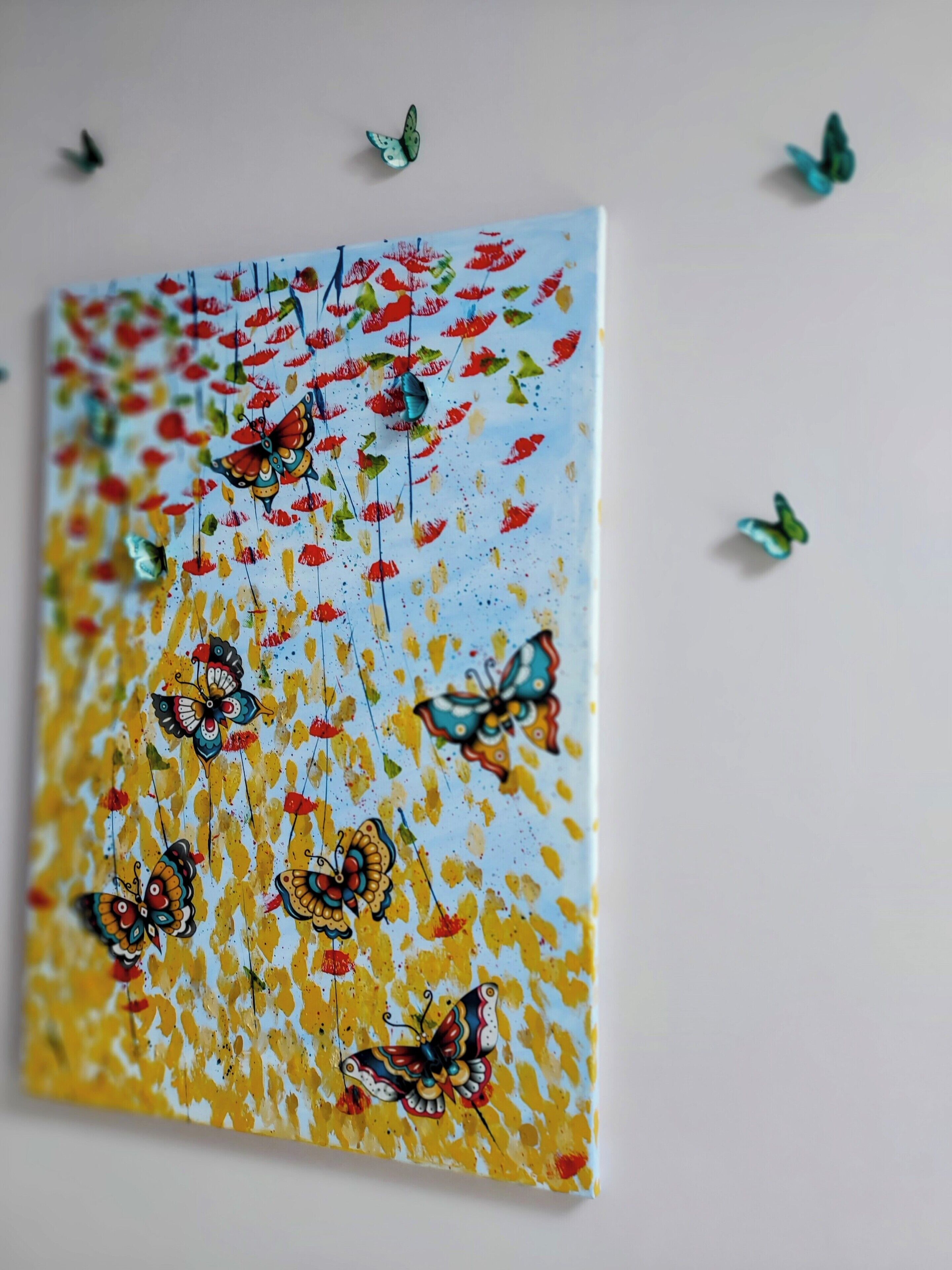 A wall with a colorful painting of butterflies and flowers.
