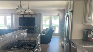 A modern kitchen with granite countertops, stainless steel appliances, and a large island.