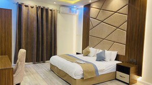 A modern bedroom with a large bed, a bedside table, a chair, and an air conditioning unit. - Lordy Serviced Apartments (Riyadh)
