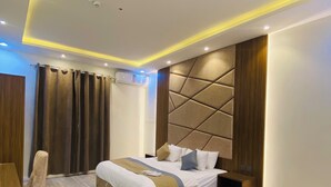 A modern bedroom with a large bed, wooden headboard, and a built-in nightstand. - Lordy Serviced Apartments (Riyadh)