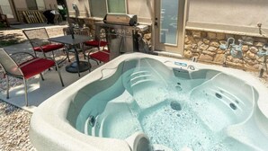An outdoor hot tub area with a barbecue grill, patio furniture, and a stone wall. - 30% OFF PROMO! East Ogden Dream, Newly Built, BBQ, Patio, Views, Dedicated Spa! (Ogden)