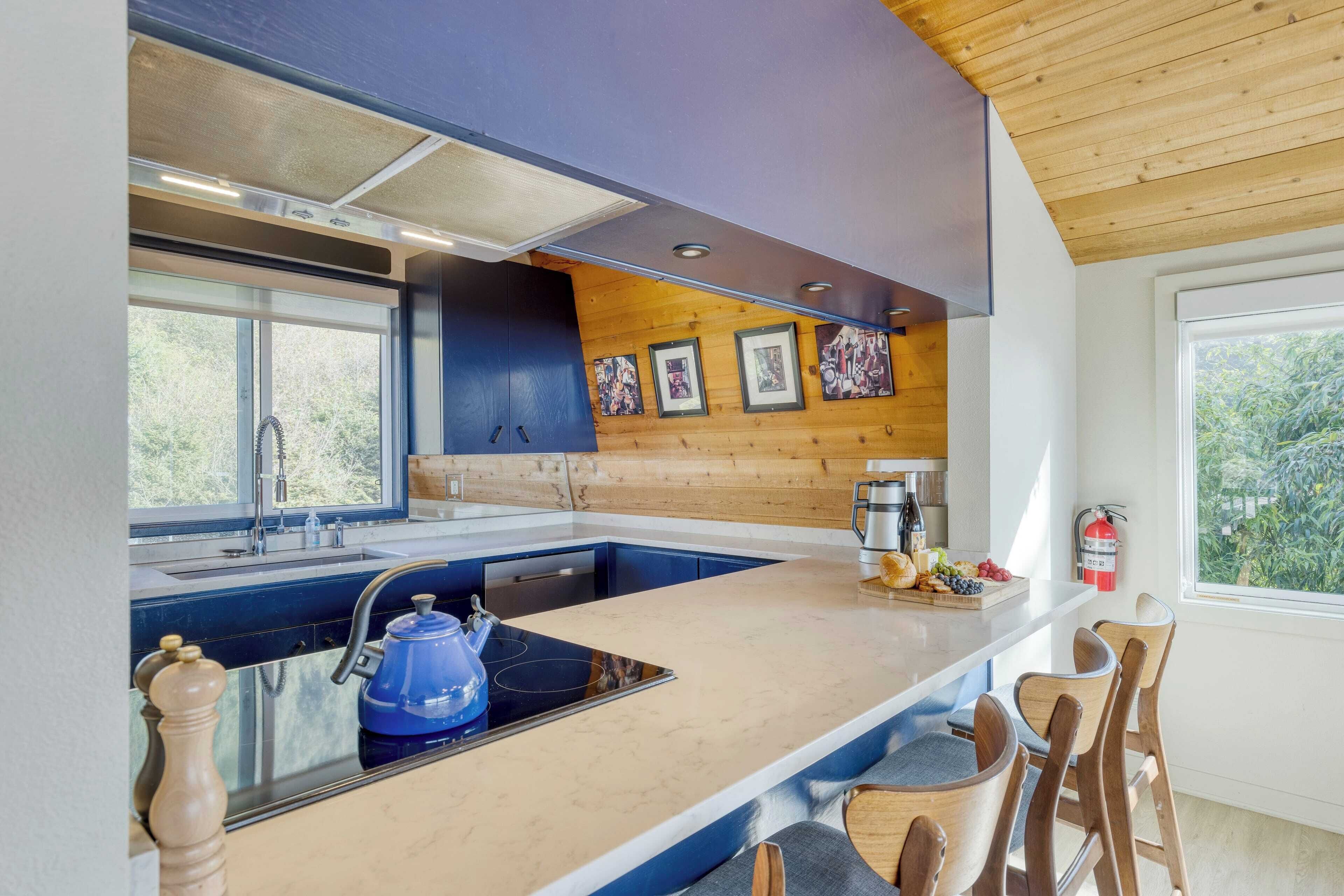 Una cocina moderna con una isla grande, armarios de madera y vistas al exterior.
