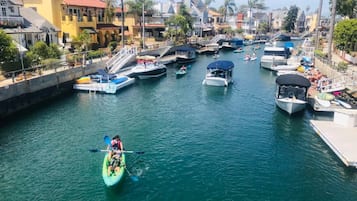 Enjoy water sports and scenic views from this marina, where kayaks and boats are docked.
