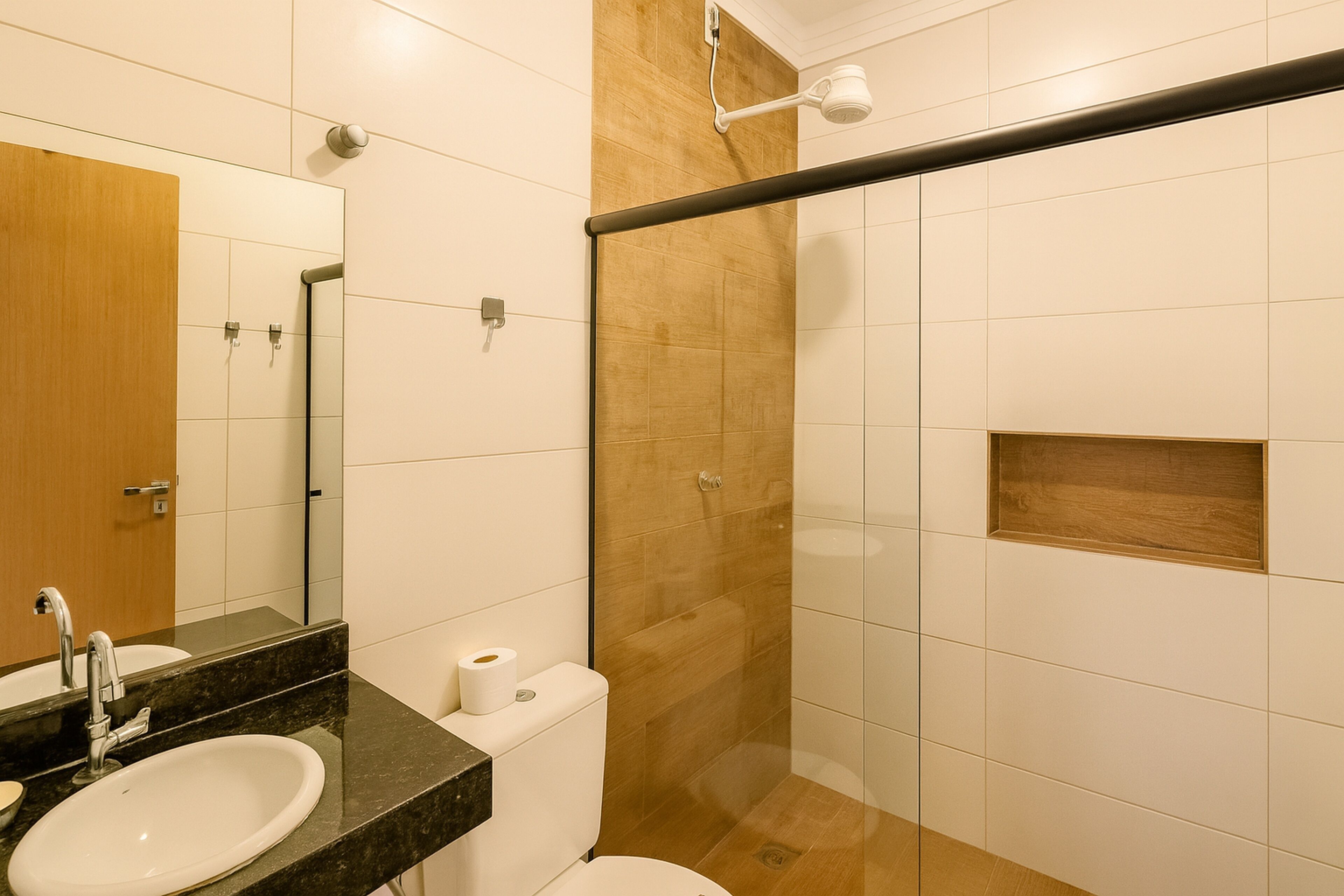 A modern bathroom with a sink, toilet, and shower area.