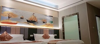 Q+ Nanxiong Xinhewan Business Hotel