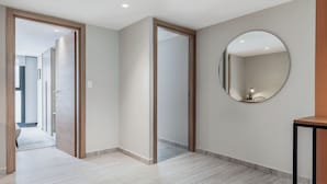 A hallway with wooden doors, a round mirror on the wall, and a tiled floor. - Blueground Mexico City JVM 429 (Mexico City)