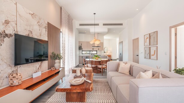 A modern living room with a flat-screen TV, wooden coffee table, and beige sofa. - Vista Alta 208 in Punta Cana (Punta Cana)