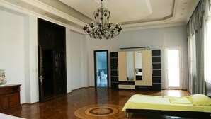 A spacious bedroom with a large bed, a chandelier, a wardrobe, and a mirror. - Premier Villas (Baku)