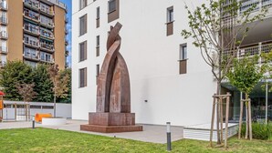 Un edificio moderno con una escultura única en el patio.