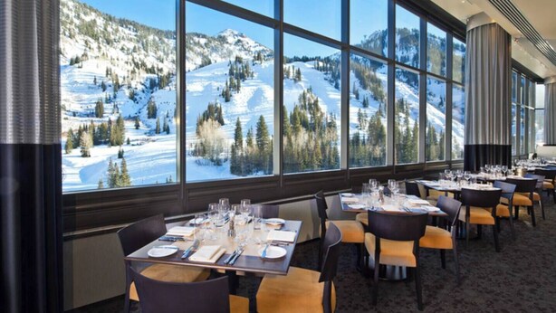A restaurant with tables set for dining, large windows offering a view of a snowy mountain landscape. - 2BR Cliff Club Retreat – Ski-In/Ski-Out! (Sandy)
