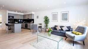 A modern apartment with a kitchen, dining area, and living room. - Oxford Circus Apartments (London)