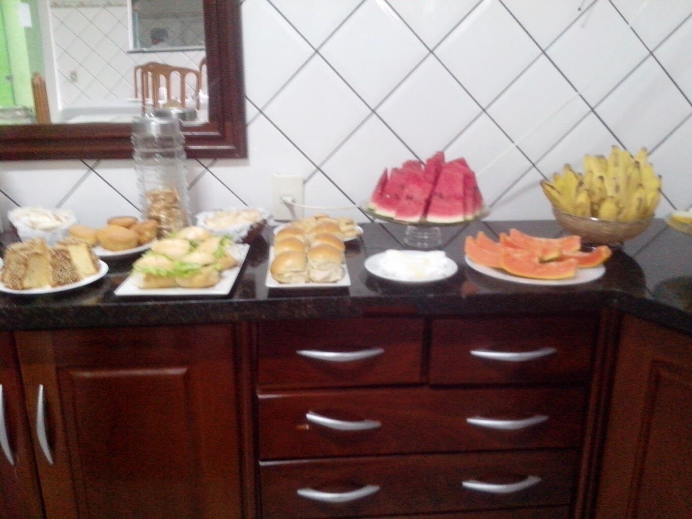 A kitchen counter with various food items and a water dispenser.