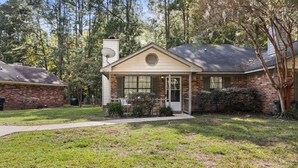 A single-story house with a brick exterior, a front porch, and a satellite dish. - The Pine Grove Retreat (Ladson)