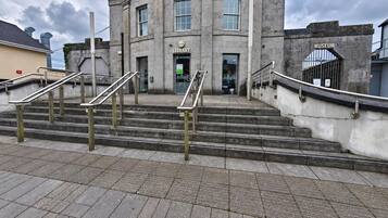 A building with a staircase leading to a library and museum entrance.