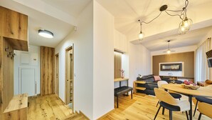 Une cuisine moderne avec des éléments en bois et un coin repas comprenant une table et des chaises en bois.
