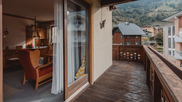 A wooden balcony with a view of a mountain landscape. - Schmuckstück by Interhome (Bad Hofgastein)
