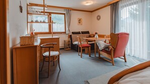 A cozy room with a bed, a desk, a chair, a table, and a window. - Schmuckstück by Interhome (Bad Hofgastein)