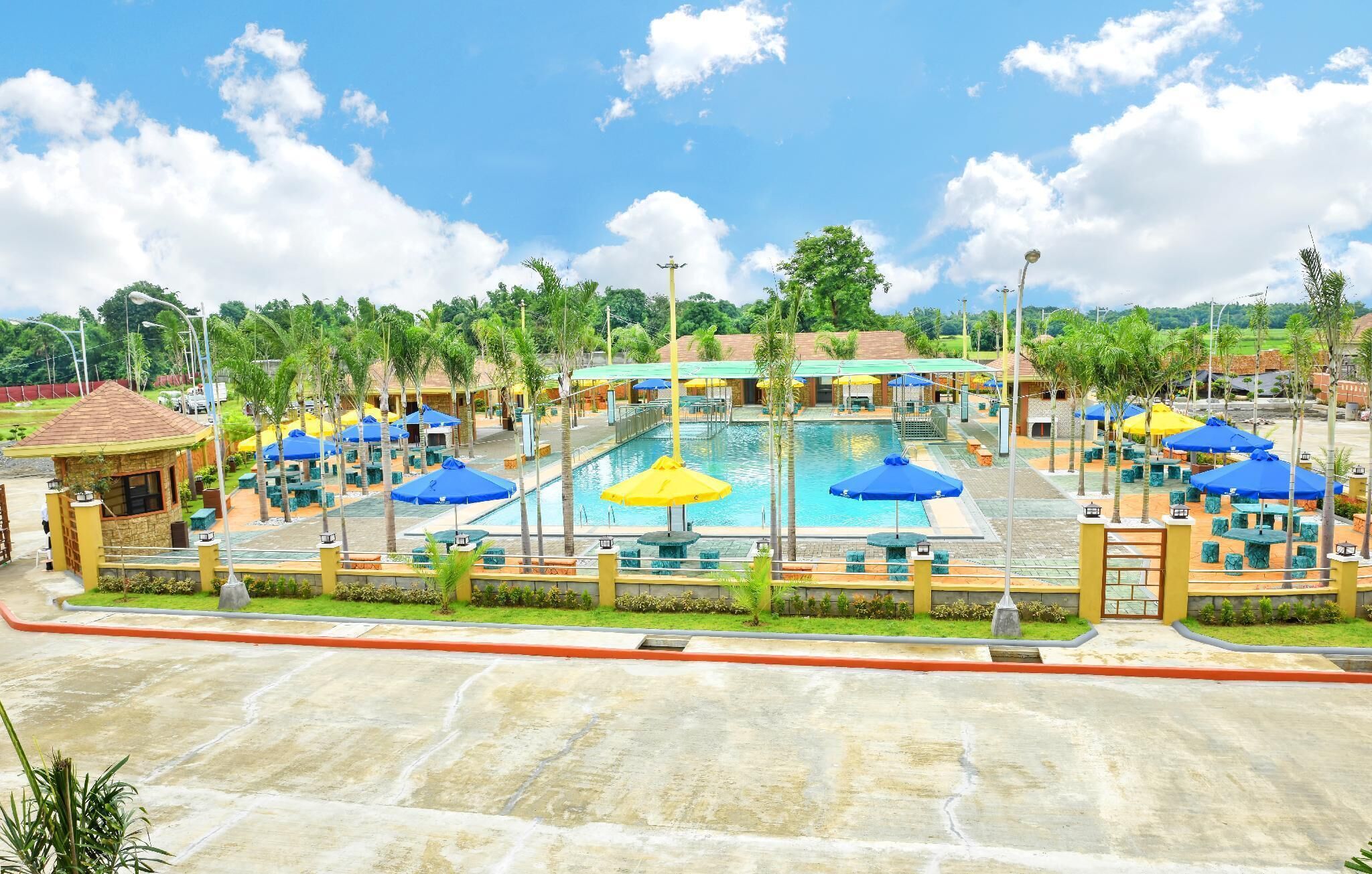 A resort with multiple swimming pools, outdoor seating areas, and a well-maintained landscape.