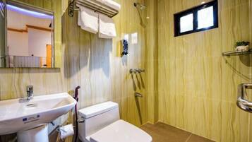 A bathroom with a sink, toilet, and shower.
