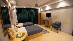 A hotel room with two beds, a desk, a chair, a TV, and a wardrobe. - King Tut Hotel Museum & Pyramids View (Giza)