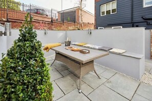 Enjoy dining al fresco in this outdoor space with a wicker table set.