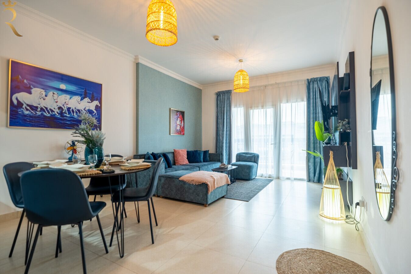 A modern living room with a dining area, a sofa set, and a large painting on the wall.