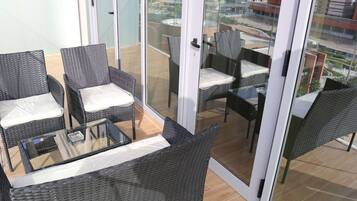 Enjoy cozy moments on a beautifully designed balcony with plush seating and serene surroundings.