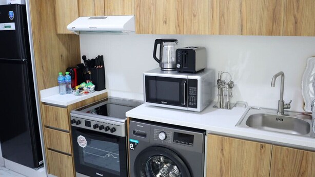 Coffee/tea maker, fridge, microwave, oven - City Nest - 2BR apartment. (Abu Dhabi)