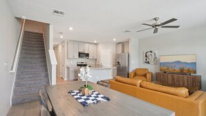 A modern kitchen with white cabinets, a microwave, and a refrigerator. - Comfortable 3-Bedroom Home – Sleeps 7 – Perfect for Vacation in Nokomis, FL (Nokomis)