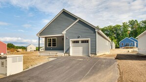 A single-story house with a garage, a front porch, and a driveway. - Walk to Beaches & Parks: Home w/ Deck in Laconia (Laconia)