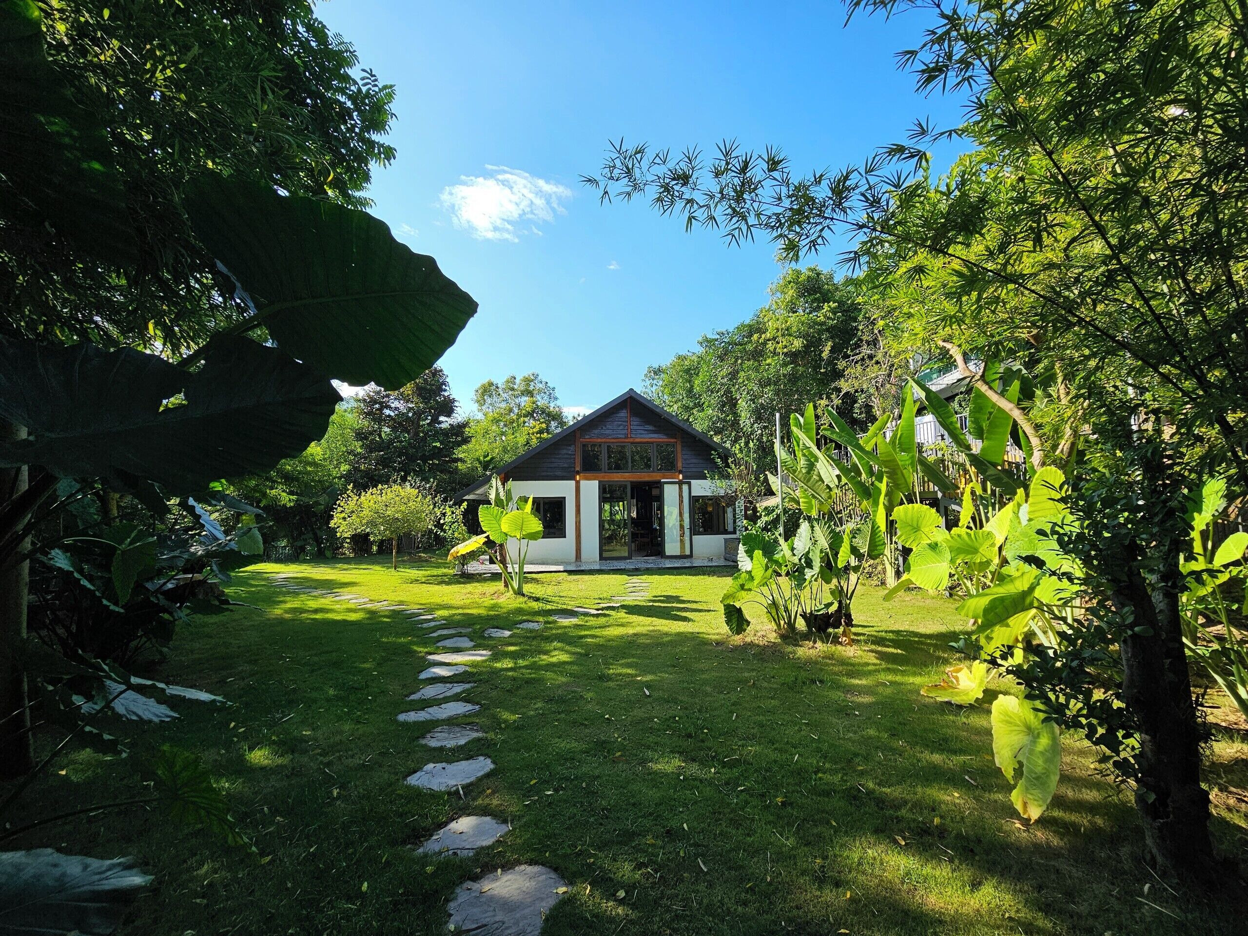 A house with a garden path leading to a wooden door.