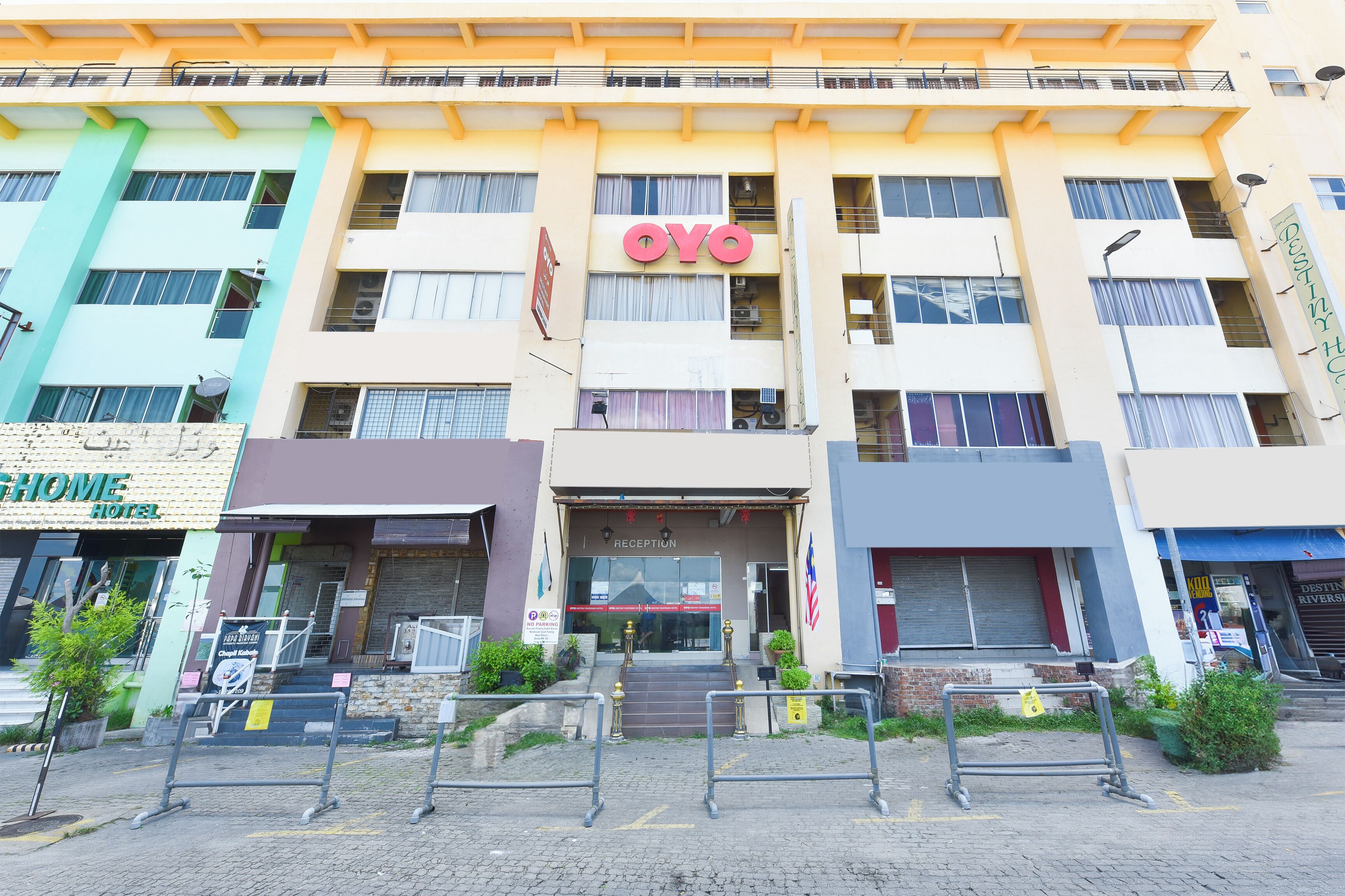 Un hotel con recepción, varios pisos y un cartel que dice 'OYO'.