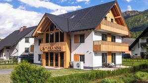A two-story boutique hotel with a prominent sign, large windows, and a sloped roof. - Vila Nina Bohinj (Bohinj)