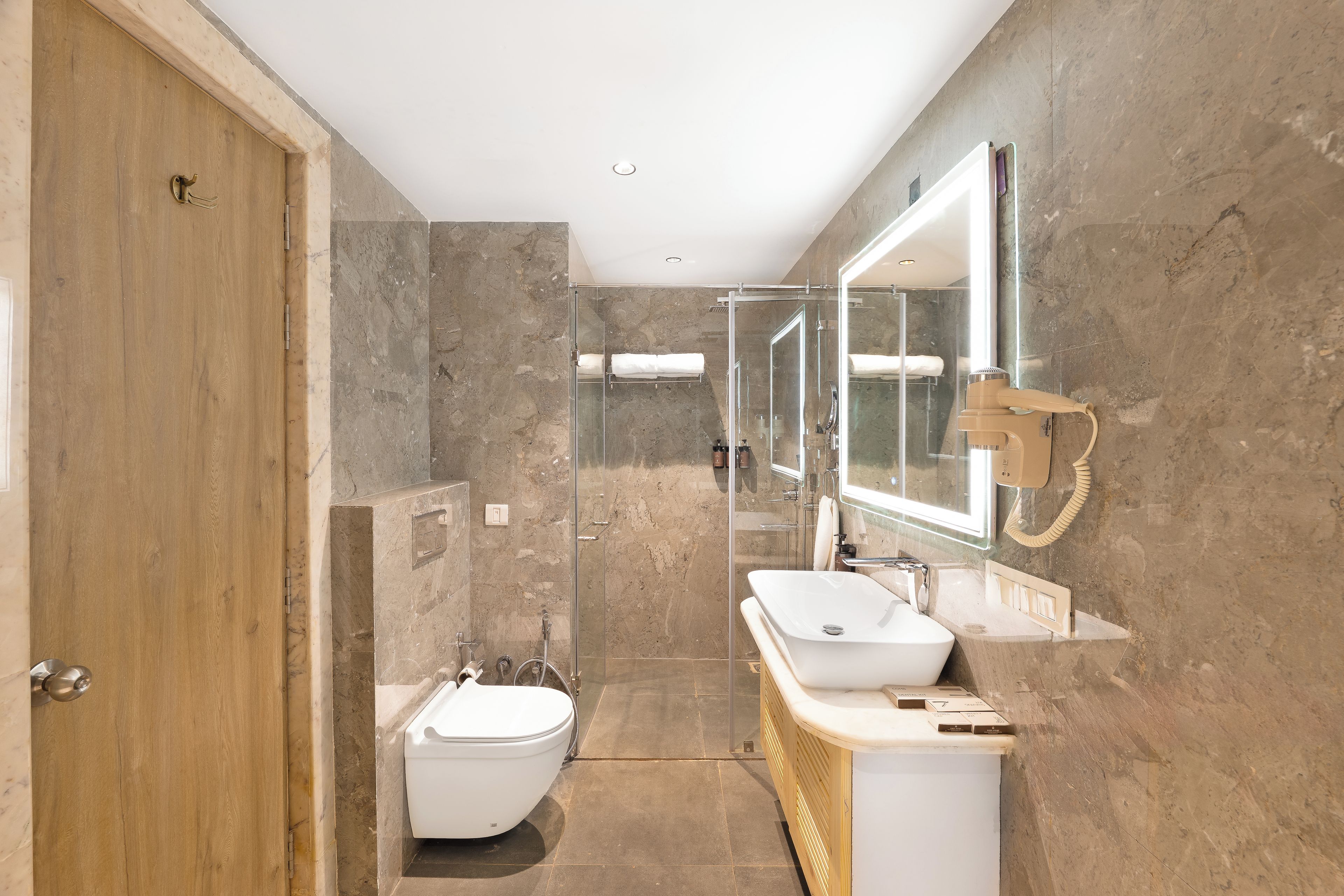 A modern bathroom with a freestanding bathtub, a sink, and a large mirror.