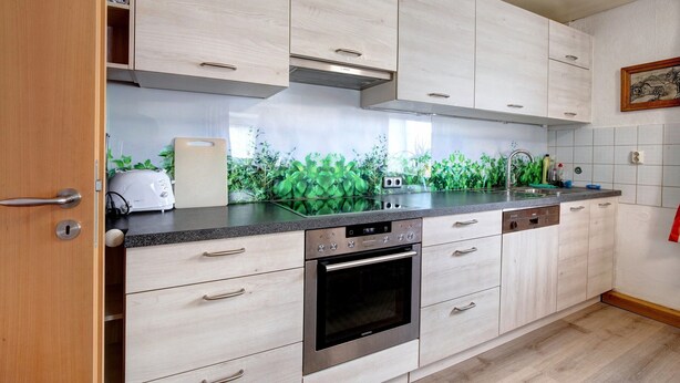 A modern kitchen with light wood cabinets, a stainless steel oven, and a toaster. - Holiday Home 'Haus Steinheim' with Shared Terrace, Garden, and Wi-Fi (Dillingen an der Donau)
