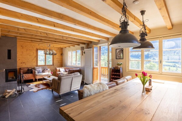 Enjoy a warm and inviting cabin retreat with a spacious dining area, cozy seating, and a fireplace.
