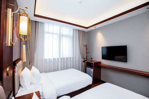 A hotel room with two beds, a flat-screen TV, a desk with a computer, and a large window with curtains. - The Yard Hotel Beijing Nanluogu Alley (Beijing)
