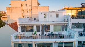 A multi-story building with balconies and large windows. - Achilleas 2-bedroom apartment (Athina)