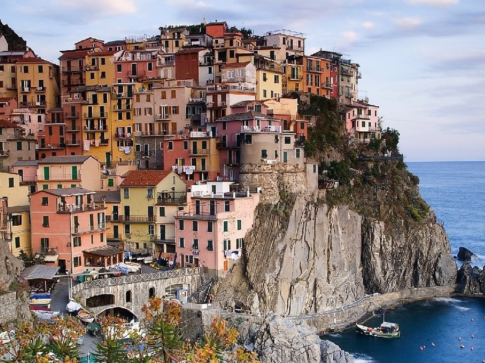 A coastal village with colorful buildings perched on a cliff overlooking the sea.