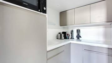 Fridge, microwave, stovetop, coffee/tea maker