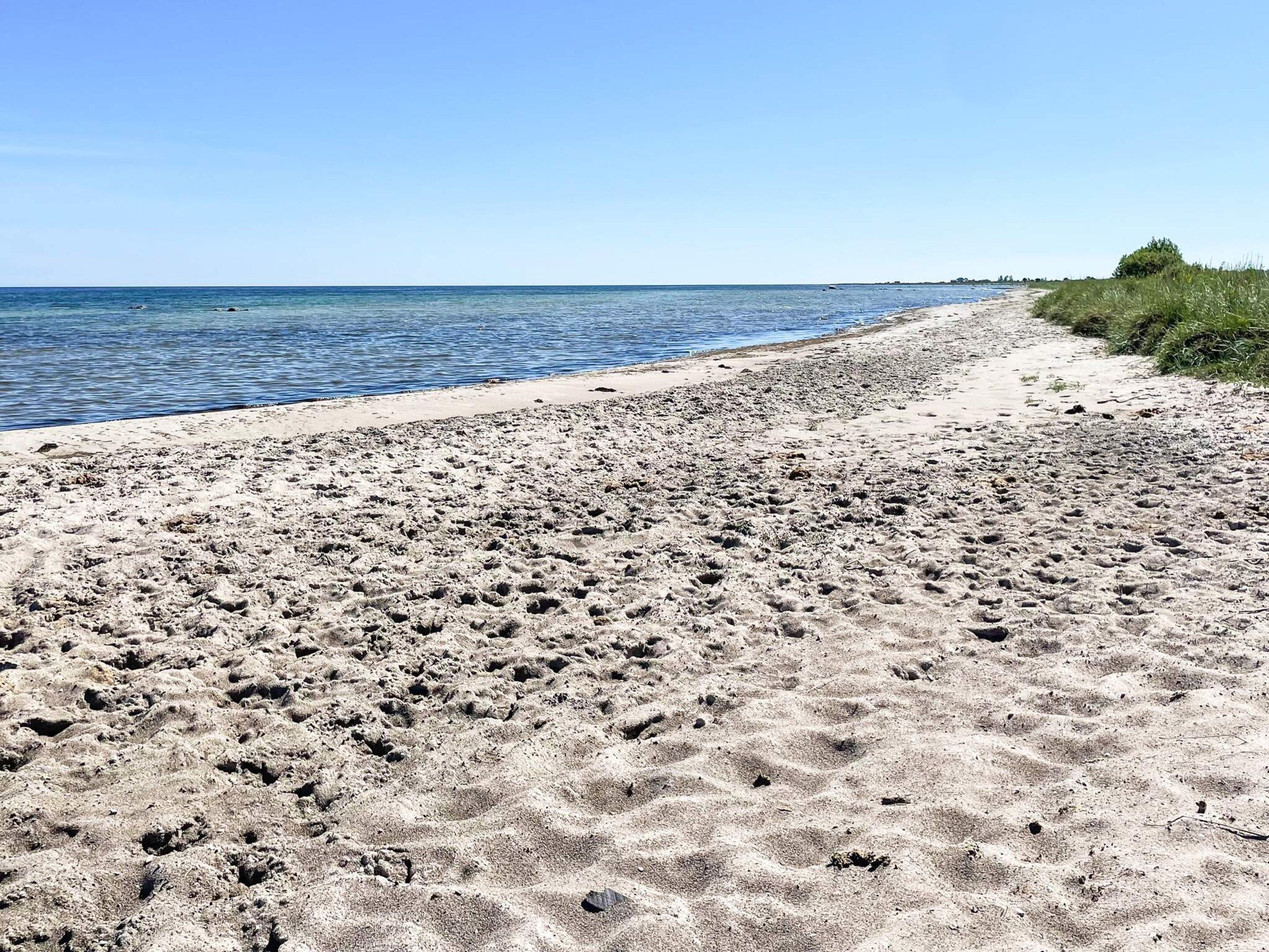 A sandy beach with a clear sky.