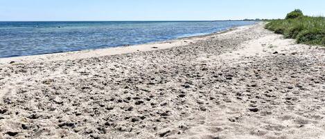 A sandy beach with a clear sky.