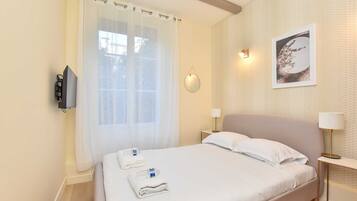 1 bedroom, desk, iron/ironing board, travel crib