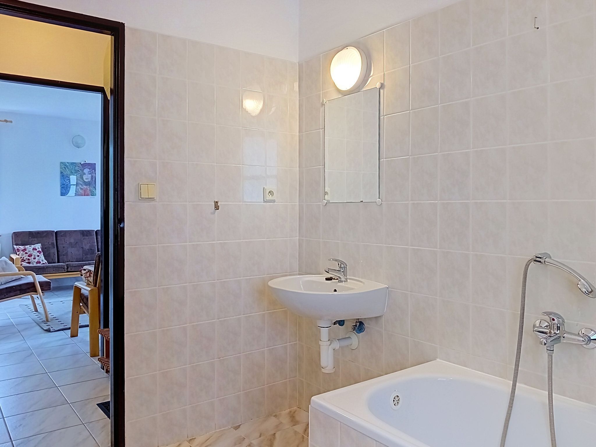 A bathroom with a bathtub, a sink, and a shower.