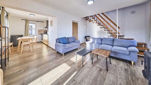 A modern apartment with a living room, dining area, kitchen, and a staircase. - Green Valley Park Stárkov 20 by Interhome (Stárkov)