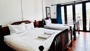 A hotel room with two single beds, a large window with a view, and a balcony. - Domon Riverside Hotel (Vang Vieng)