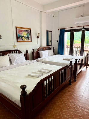 Deluxe Quadruple Room, Balcony, Mountain View | Desk, free WiFi, bed sheets - Domon Riverside Hotel (Vang Vieng)