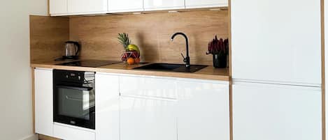 Superior Apartment, Courtyard View | Private kitchen | Electric kettle, griddle, cleaning supplies, freezer