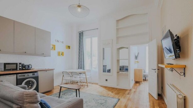 A modern apartment with a kitchen, living area, and a dining space.