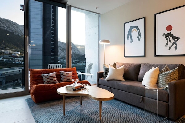 Cozy living room with floor-to-ceiling windows and stunning mountain views